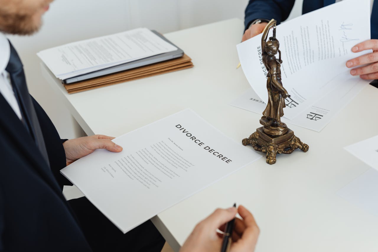 Mastering the First Impression: Your intriguing post title goes here Two professionals discuss divorce decree documents, focusing on legal negotiations.